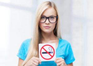 Woman holding no smoking sign